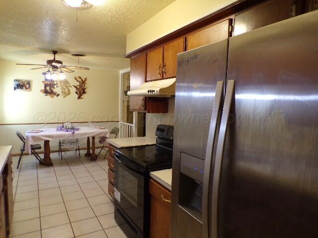 1620 Bluebell Street Amarillo, TX 79107 - Photo 9 of 28 a kitchen with stainless steel appliances granite countertop a sink and a refrigerator