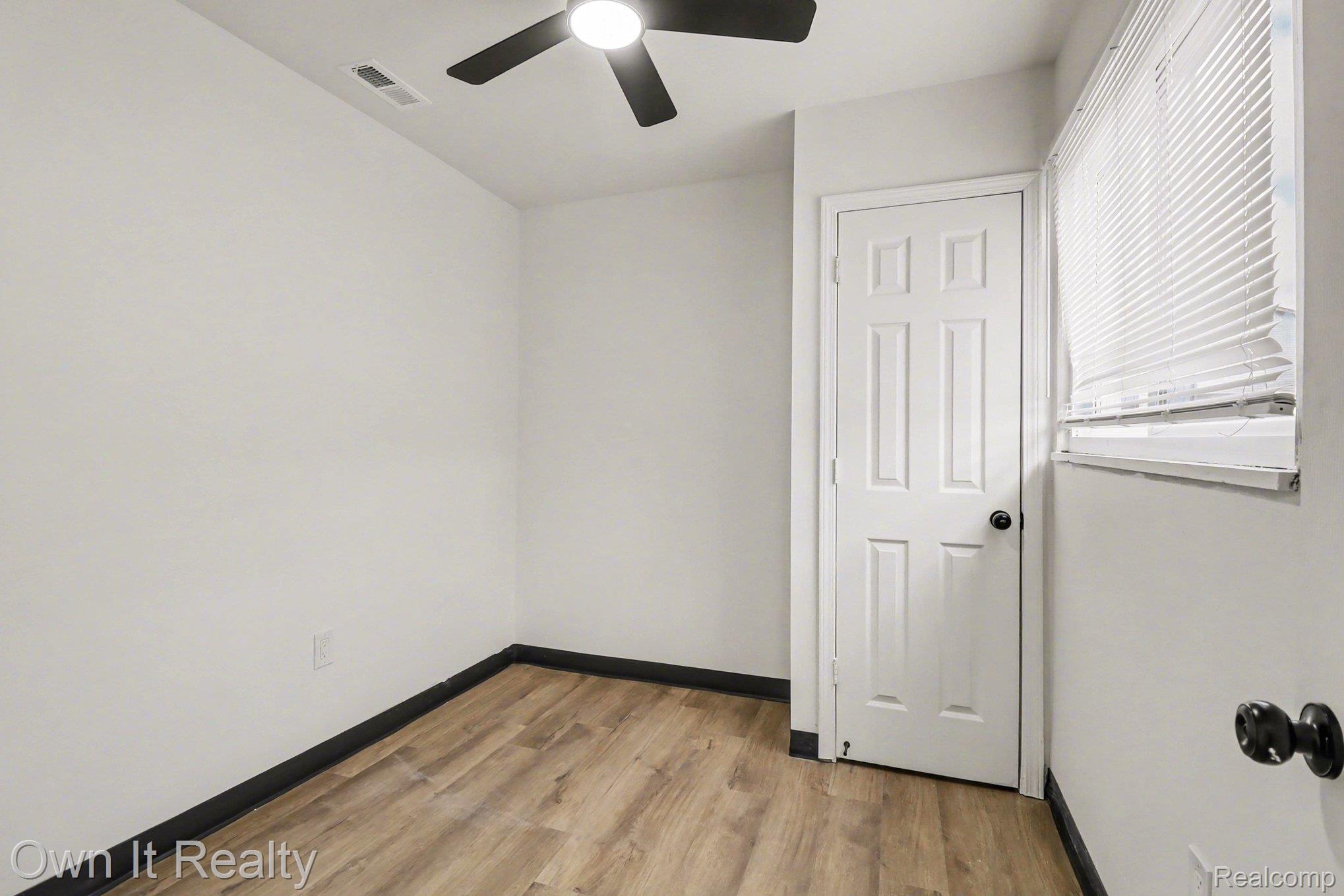 3 Joy Road, Unit 3 Detroit, MI 48228 - Photo 33 of 37 Unfurnished bedroom with light wood-type flooring and a ceiling fan
