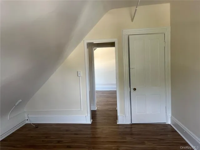 a view of room with wooden floor