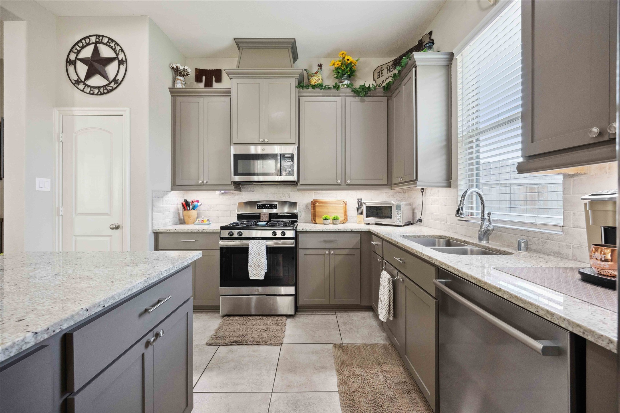 323 Biltmore Loop Montgomery, TX 77316 - Photo 9 of 27 Spacious kitchen with quartz island and stylish subway tile backsplash.