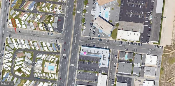 a front view of a building with a tree
