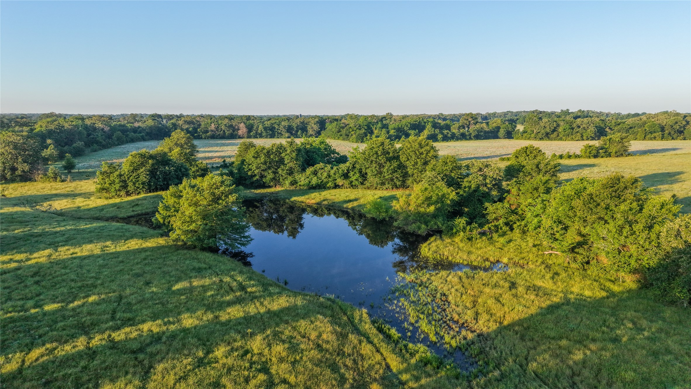 3765 Poteet Road Normangee, TX 77871 - Photo 13 of 37 a view of a lake with houses in the back