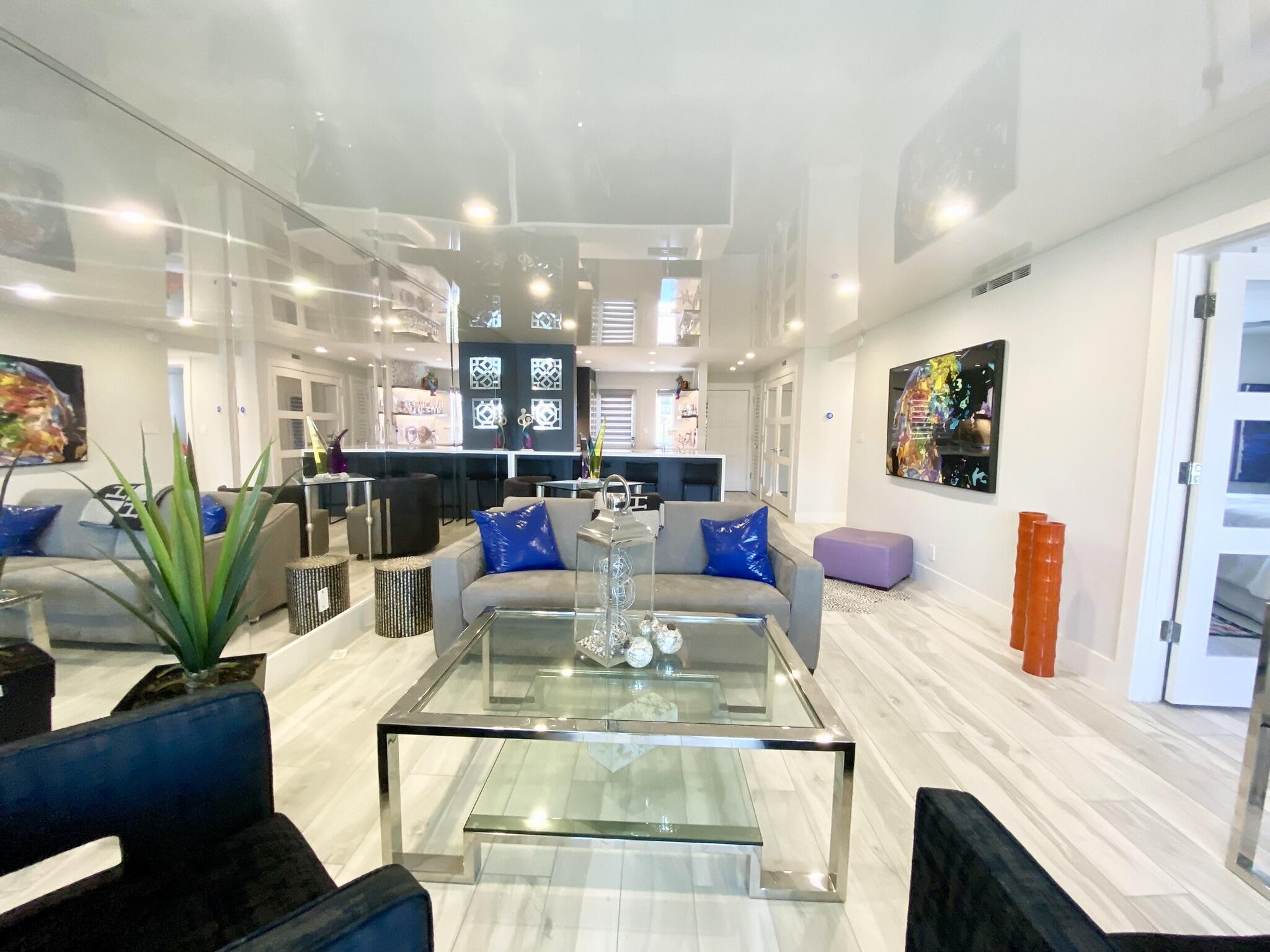 2871 North Ocean Boulevard, Unit M330 Boca Raton, FL 33431 - Photo 13 of 60 a living room with kitchen island furniture and a chandelier