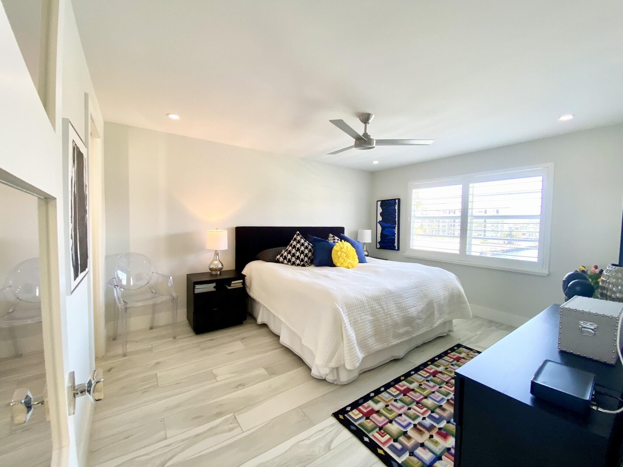 2871 North Ocean Boulevard, Unit M330 Boca Raton, FL 33431 - Photo 17 of 60 a bedroom with a bed and wooden floor
