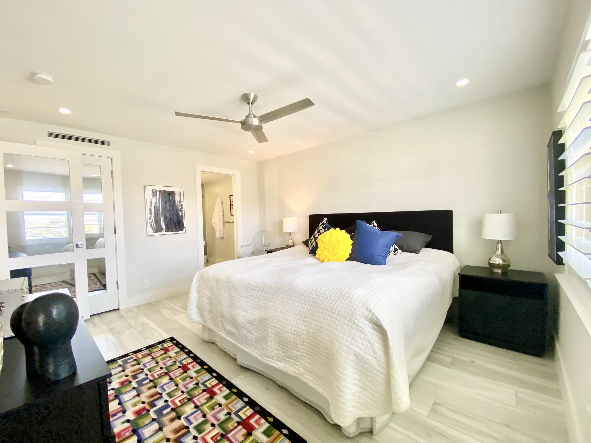 2871 North Ocean Boulevard, Unit M330 Boca Raton, FL 33431 - Photo 18 of 60 a bedroom with a bed and wooden floor