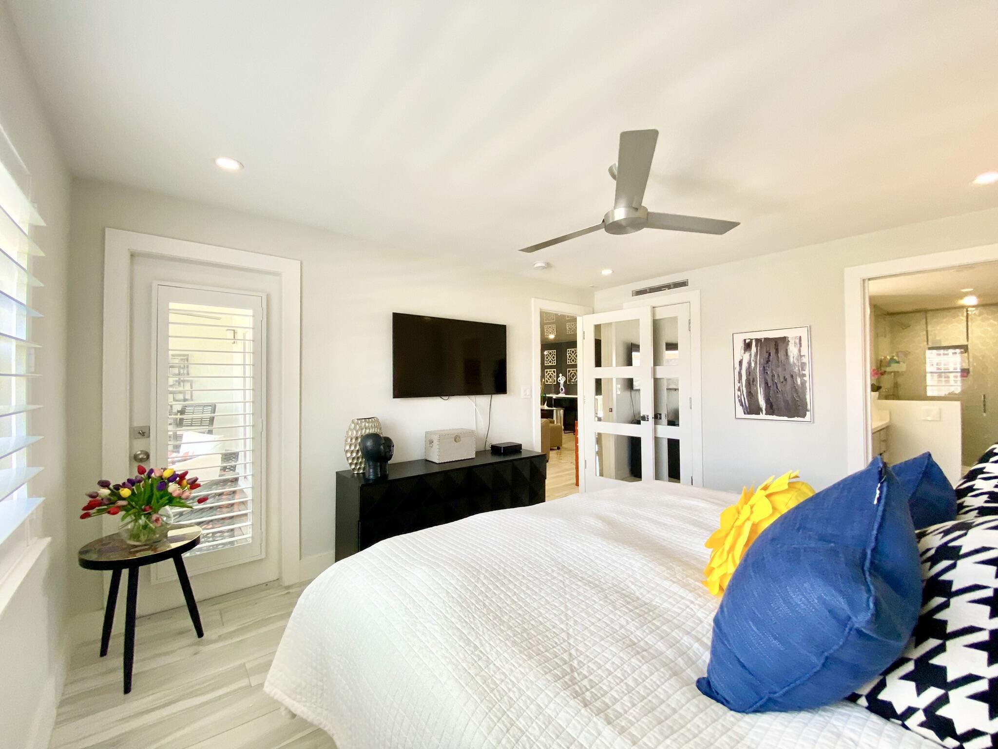 2871 North Ocean Boulevard, Unit M330 Boca Raton, FL 33431 - Photo 19 of 60 a bedroom with a bed and a flat screen tv