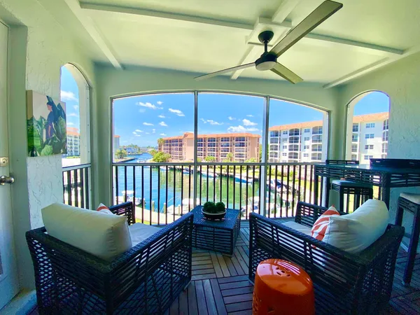 a balcony with furniture and a potted plant