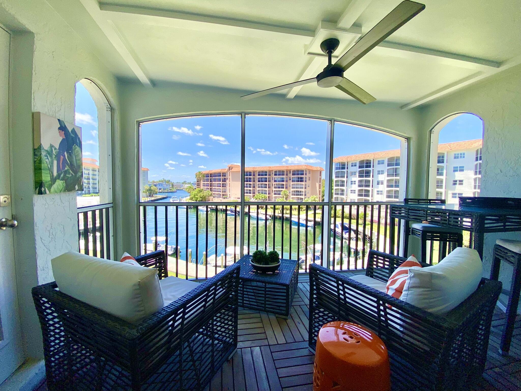 2871 North Ocean Boulevard, Unit M330 Boca Raton, FL 33431 - Photo 2 of 60 a balcony with furniture and a potted plant