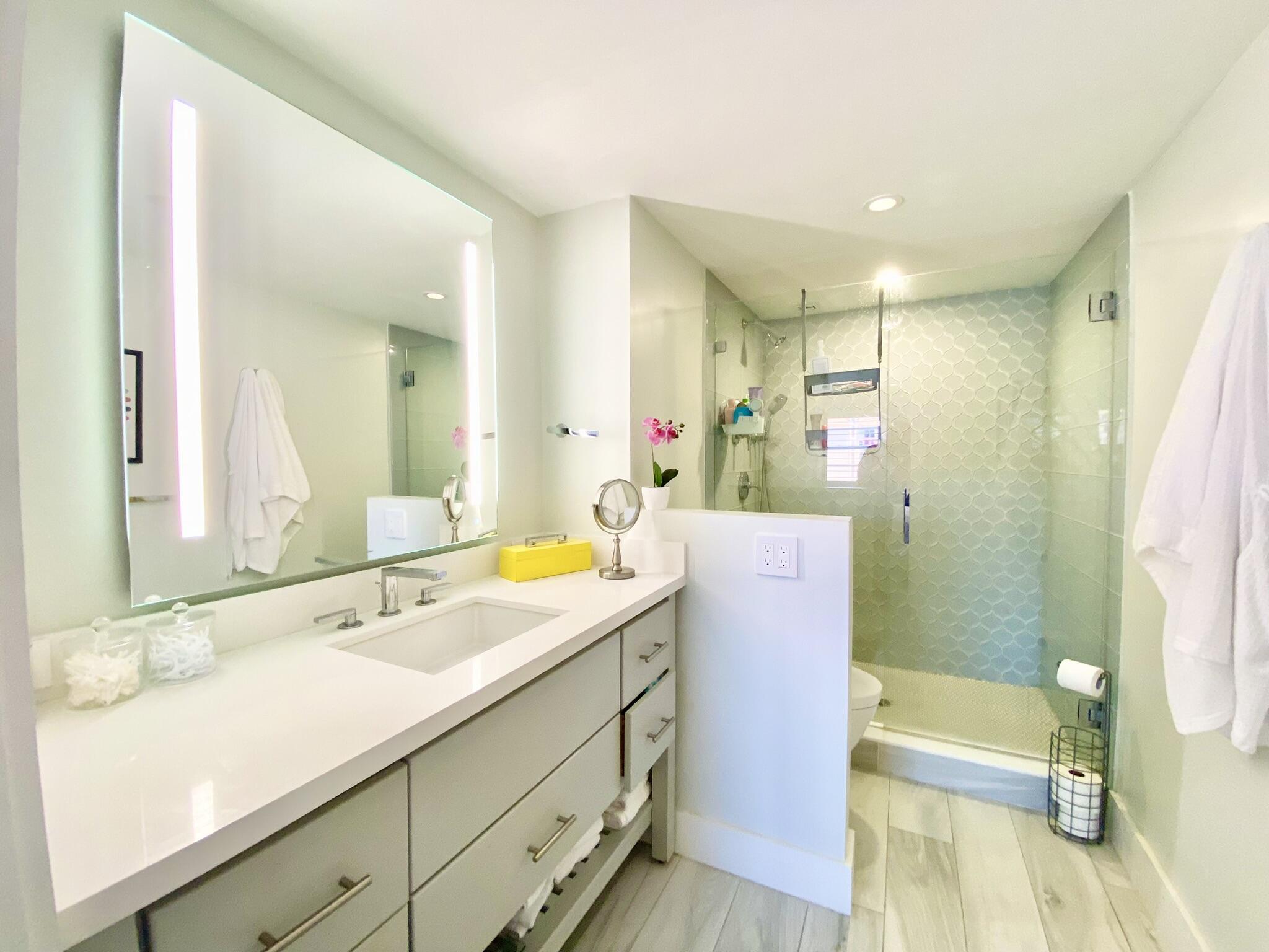 2871 North Ocean Boulevard, Unit M330 Boca Raton, FL 33431 - Photo 21 of 60 a bathroom with a sink double vanity and a mirror