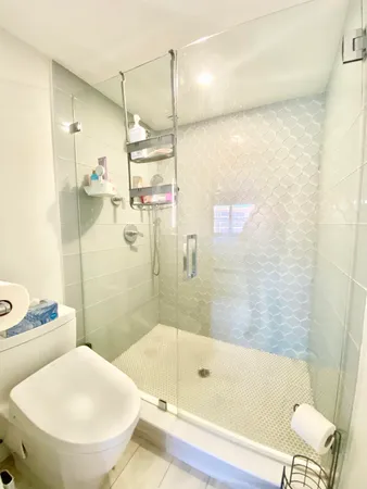 a bedroom with a bed and dresser with mirror