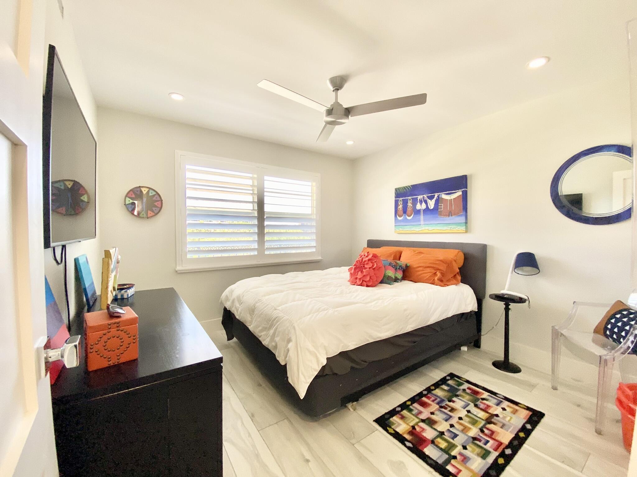 2871 North Ocean Boulevard, Unit M330 Boca Raton, FL 33431 - Photo 25 of 60 a bedroom with a bed and dresser with mirror