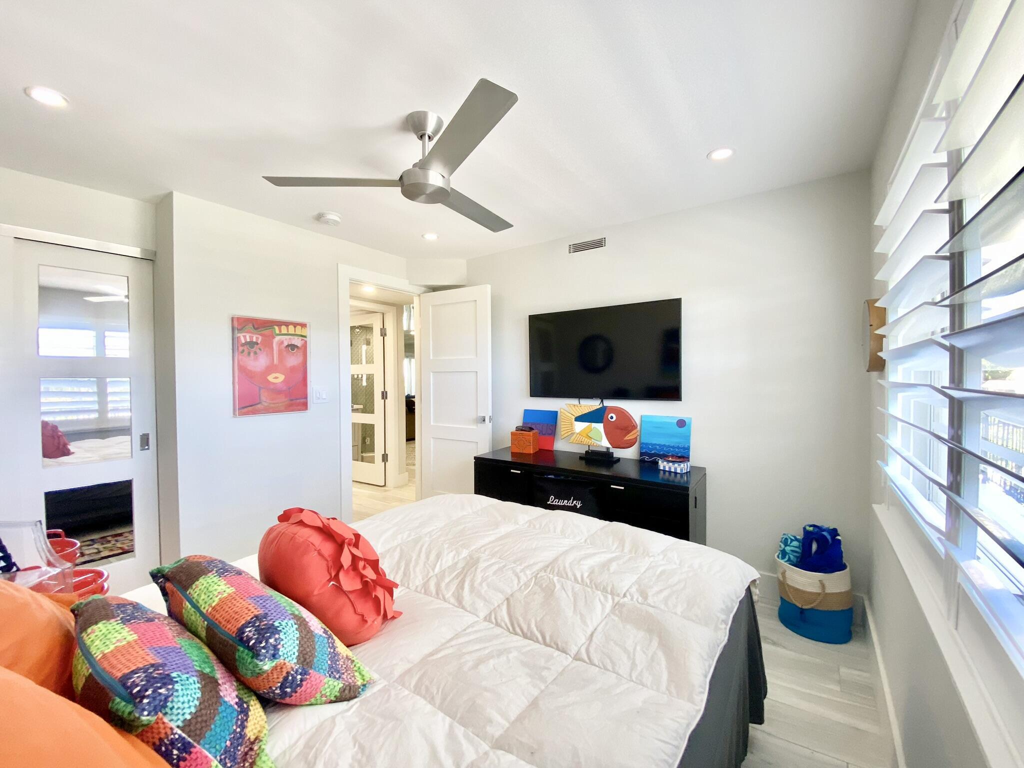 2871 North Ocean Boulevard, Unit M330 Boca Raton, FL 33431 - Photo 26 of 60 a bedroom with bed and a flat tv screen on the dresser