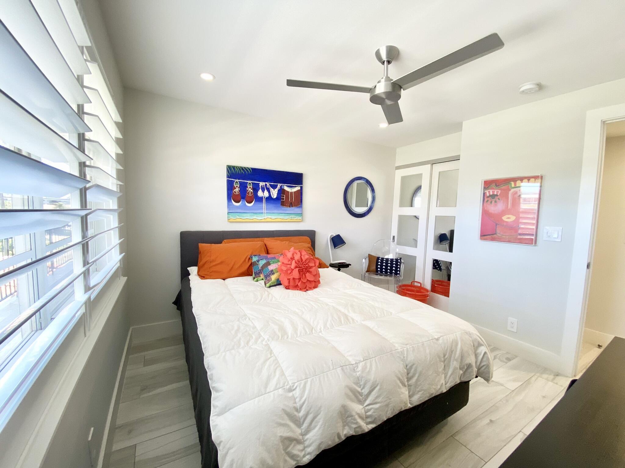 2871 North Ocean Boulevard, Unit M330 Boca Raton, FL 33431 - Photo 27 of 60 a bedroom with a bed and a chandelier