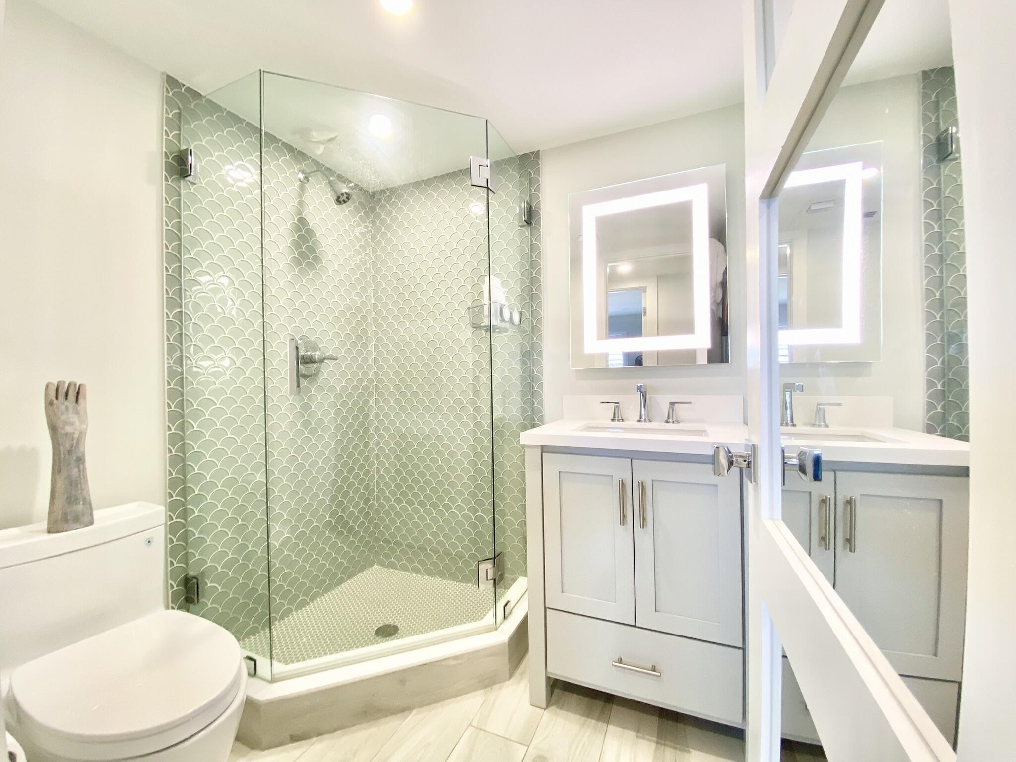 2871 North Ocean Boulevard, Unit M330 Boca Raton, FL 33431 - Photo 28 of 60 a bathroom with a sink a toilet and shower