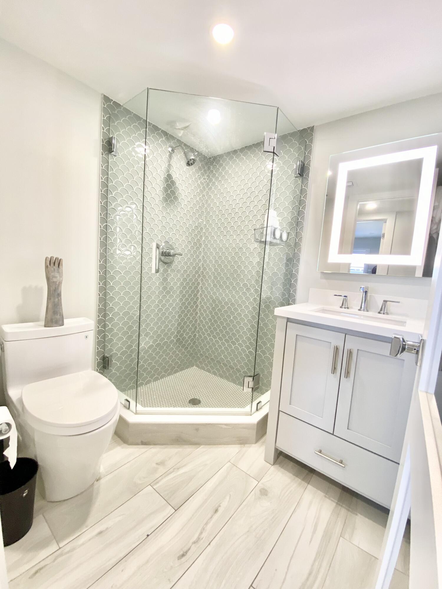 2871 North Ocean Boulevard, Unit M330 Boca Raton, FL 33431 - Photo 29 of 60 a bathroom with a sink a toilet and shower