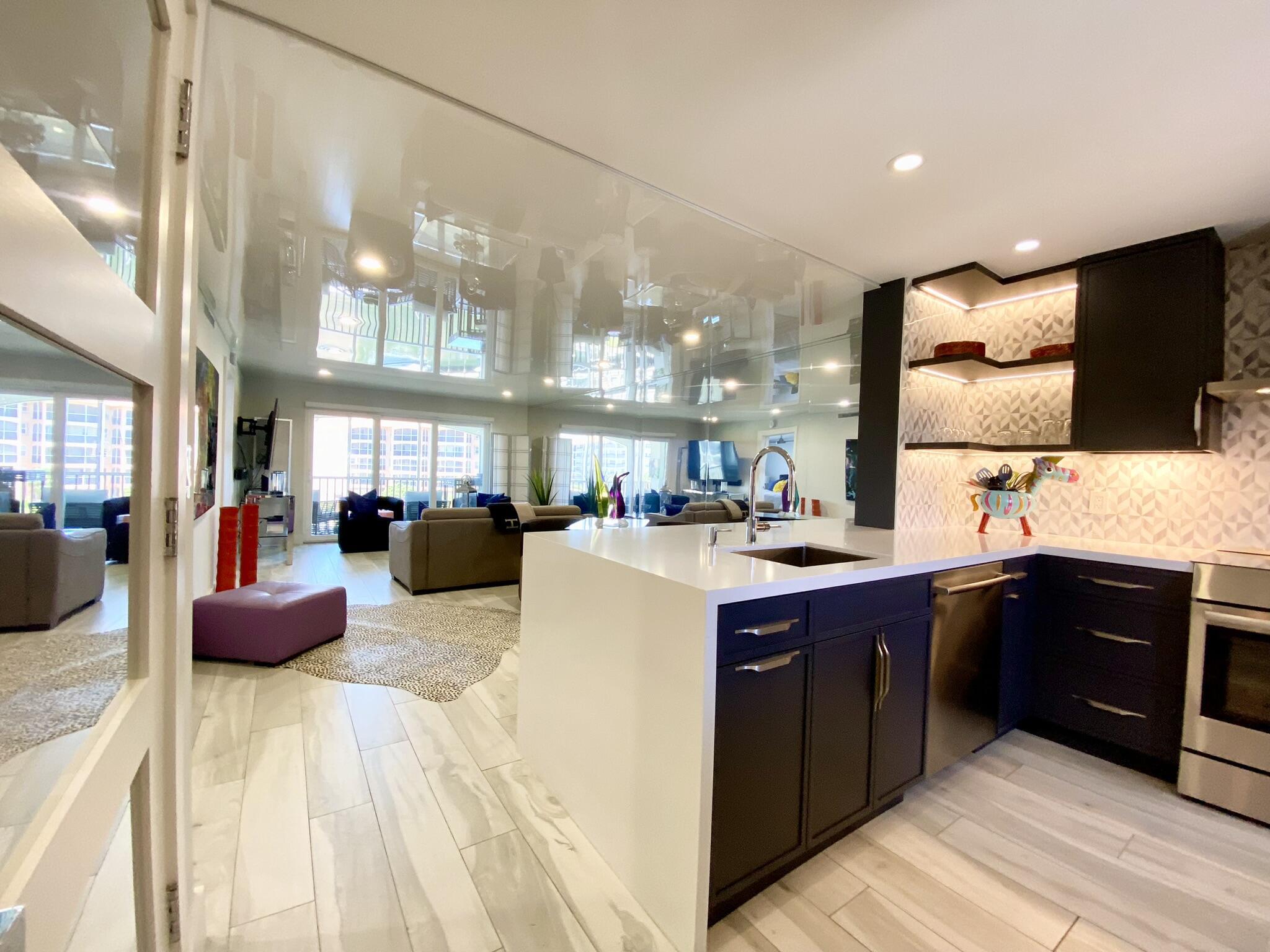 2871 North Ocean Boulevard, Unit M330 Boca Raton, FL 33431 - Photo 3 of 60 a kitchen with stainless steel appliances granite countertop a sink counter space cabinets and a couch