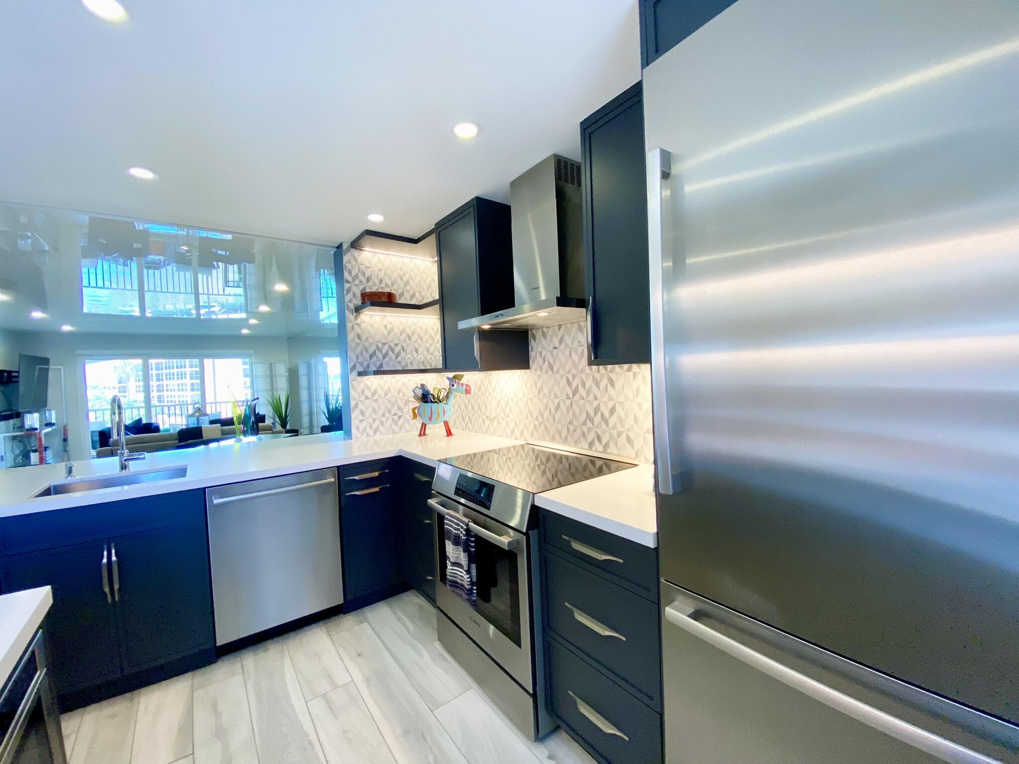 2871 North Ocean Boulevard, Unit M330 Boca Raton, FL 33431 - Photo 5 of 60 a kitchen with stainless steel appliances granite countertop sink stove and refrigerator
