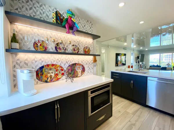 a living room with stainless steel appliances kitchen island granite countertop furniture and a kitchen view
