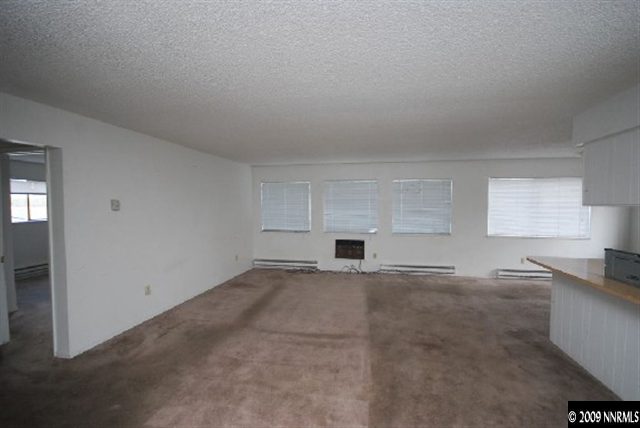 3972 Neil Road Reno, NV 89502 - Photo 6 of 9 an empty room with kitchen space and window