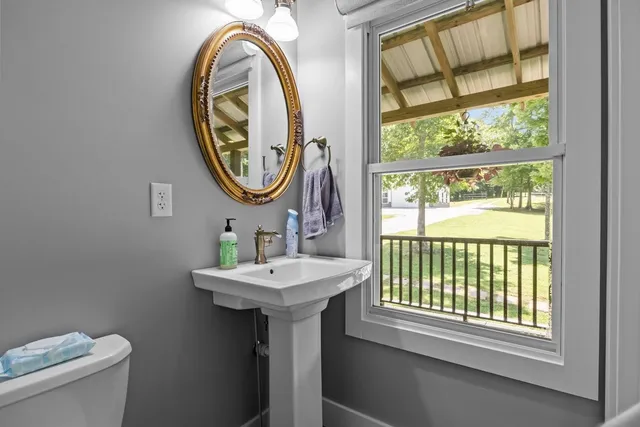 a view of a dining room with furniture a chandelier and wooden floor