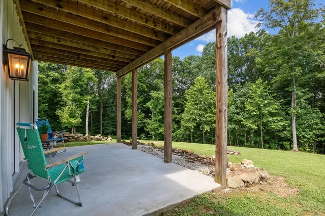 a view of a house with a big yard and potted plants