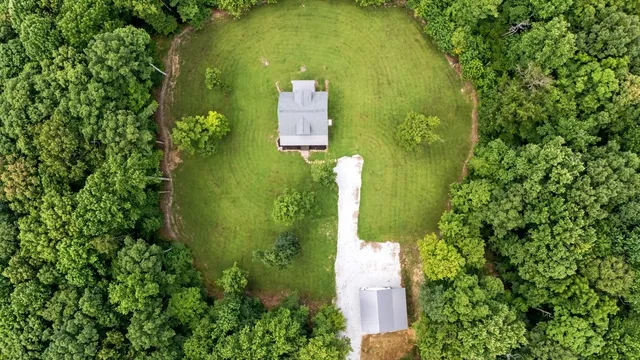 an aerial view of a house with a yard