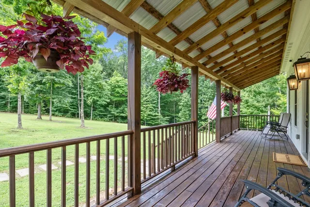 a view of backyard with a deck and wooden floor