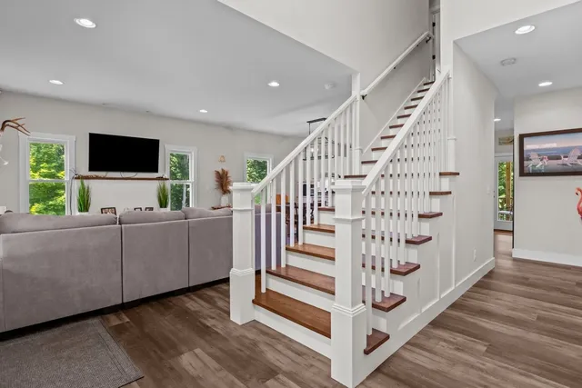 a living room with furniture and a large mirror