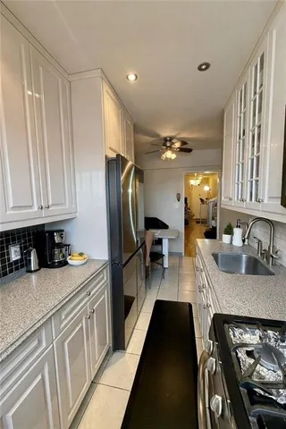 a kitchen with a refrigerator and a sink