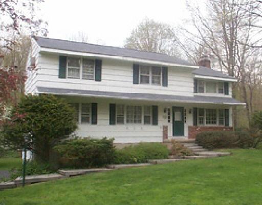 178 Peaceable Street Ridgefield, CT 06877 - Photo 1 of 1 a front view of a house with a yard and potted plants
