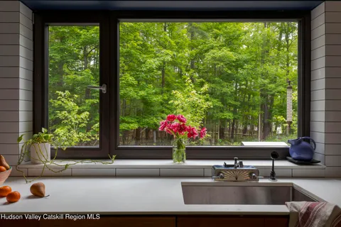 a room with a large window and sitting area