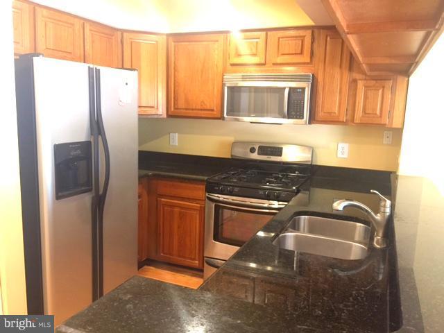 6527 Cypress Point Road Alexandria, VA 22312 - Photo 2 of 16 a kitchen with stainless steel appliances granite countertop a refrigerator and a stove