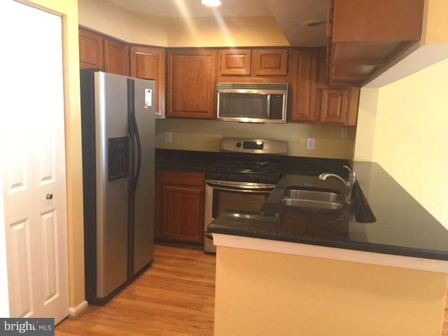 6527 Cypress Point Road Alexandria, VA 22312 - Photo 3 of 16 a kitchen with a sink and a refrigerator