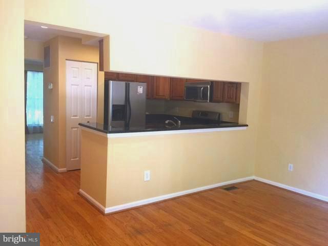 6527 Cypress Point Road Alexandria, VA 22312 - Photo 4 of 16 a view of a hallway with wooden floor