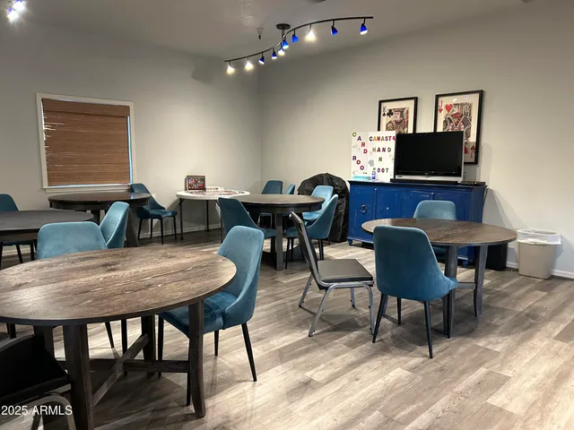 a living room with furniture and a book shelf
