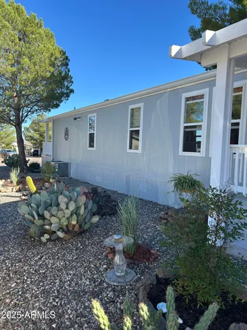a backyard of a house with a yard and outdoor seating
