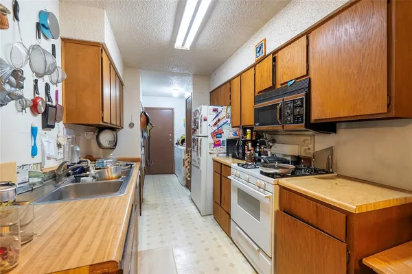 a kitchen that has a sink and a stove top oven