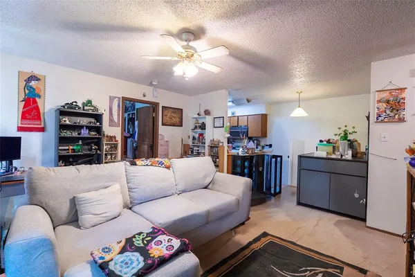 a living room with furniture and kitchen view