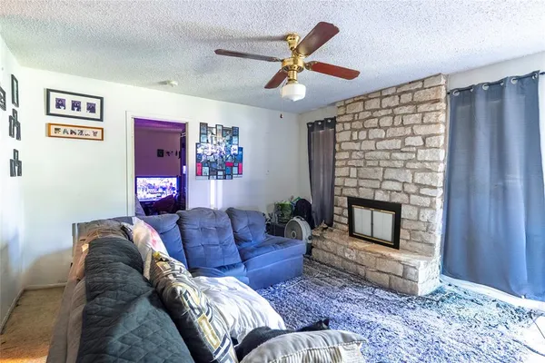 a living room with furniture a fireplace and a window