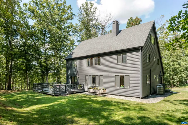 a view of a house with a yard and sitting area