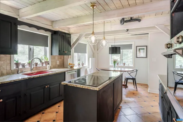 a kitchen with granite countertop a sink and cabinets