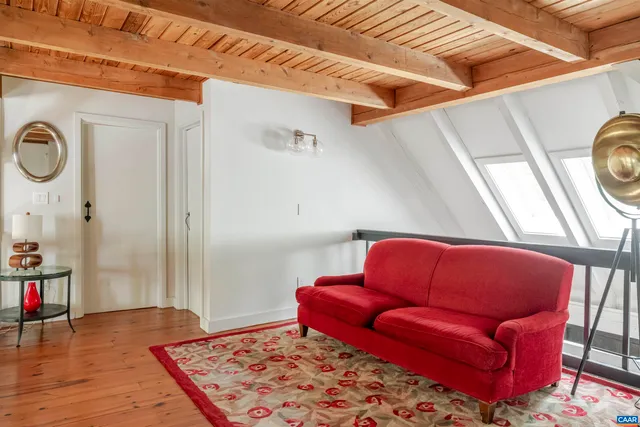 a blue couch sitting in a living room next to a window