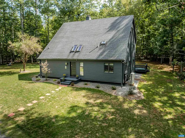 a view of a house with a yard and garage