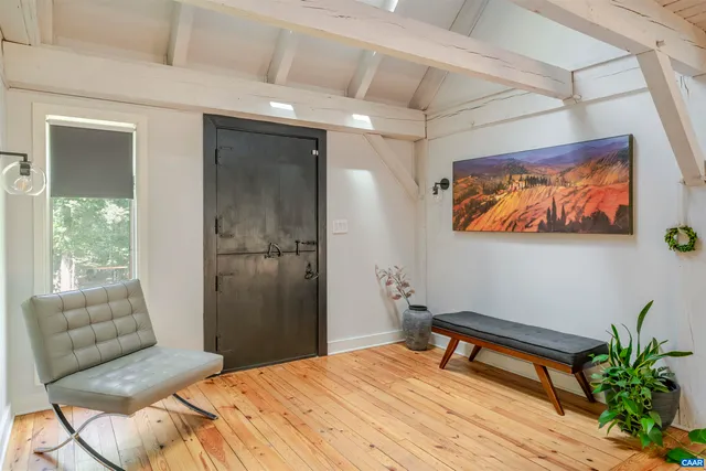 a bedroom with a bed and a painting on the wall