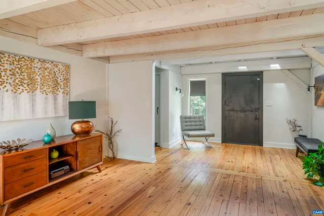 a living room with hard wood floors and a fireplace