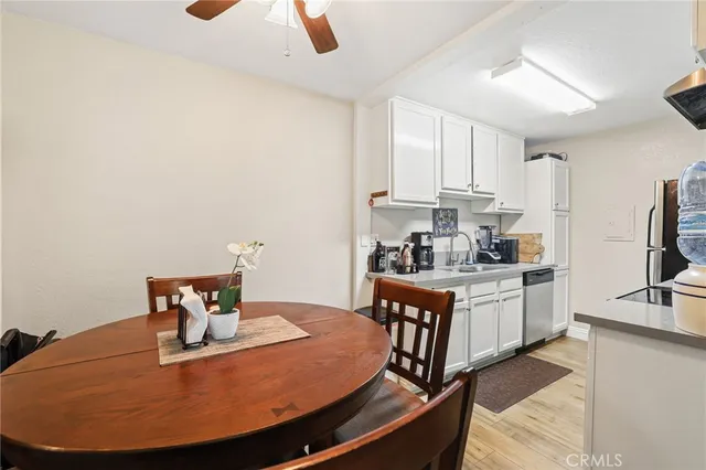 a kitchen with stainless steel appliances a sink a stove and white cabinets