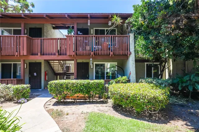 a front view of a house with yard and livingroom