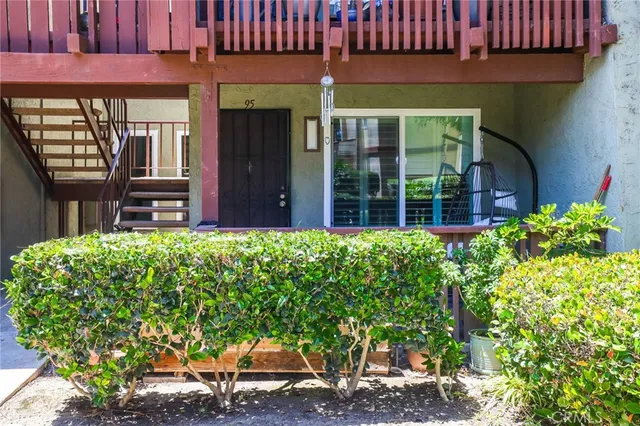 a view of a house with potted plants