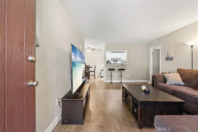 a living room with furniture and wooden floor