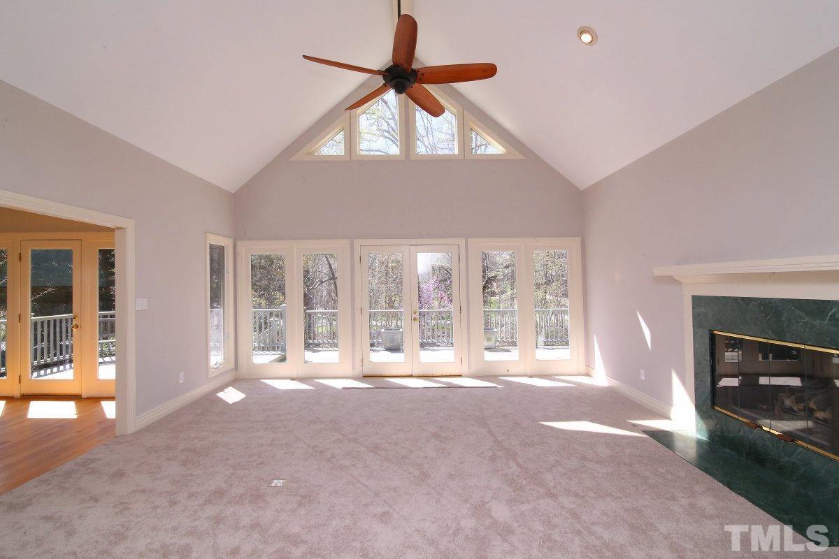 8800 Old Tom Way Raleigh, NC 27613 - Photo 2 of 25 a view of an empty room with a fireplace and a window